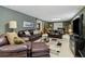 Spacious living room with dark brown leather furniture, decorative rugs, and neutral walls at 1400 Lamont Cir, Dacula, GA 30019