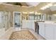 A luxurious main bathroom with dual vanities, a separate shower, and a soaking tub at 1400 Lamont Cir, Dacula, GA 30019