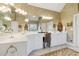 A bright main bathroom with a large mirror, white cabinets, and vanity with ample counter space at 1400 Lamont Cir, Dacula, GA 30019