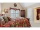 A serene main bedroom featuring a floral bedspread and a view into the bathroom at 1400 Lamont Cir, Dacula, GA 30019