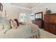 A well-lit main bedroom with hardwood furniture and soft, comfortable bedding and decor at 1400 Lamont Cir, Dacula, GA 30019