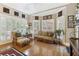 Bright sun room with ample windows, hardwood floors, and comfortable seating at 1400 Lamont Cir, Dacula, GA 30019