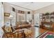 Sun room with a ceiling fan, shutters, hardwood floors, and rattan furniture at 1400 Lamont Cir, Dacula, GA 30019