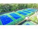 Aerial view of multiple community tennis courts surrounded by trees at 1400 Lamont Cir, Dacula, GA 30019