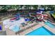 Aerial view of a community water park with multiple slides and lounge seating at 1400 Lamont Cir, Dacula, GA 30019