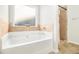 Relaxing bathroom with soaking tub, shower, and tile accents at 276 Villa Grande Dr, Locust Grove, GA 30248