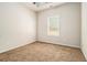 Spacious bedroom with plush carpeting and a large window at 276 Villa Grande Dr, Locust Grove, GA 30248