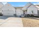 House exterior featuring a two-car garage and manicured lawn at 276 Villa Grande Dr, Locust Grove, GA 30248