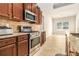 Kitchen with stainless steel appliances and wood cabinets at 276 Villa Grande Dr, Locust Grove, GA 30248