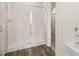 Elegant bathroom shower featuring marble tiling and wood flooring at 345 Sound Cir # 134, Stockbridge, GA 30281