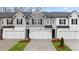 Charming new construction townhome featuring multiple units, brick accents, and manicured landscaping at 345 Sound Cir # 134, Stockbridge, GA 30281