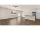 Living room with hardwood floors, flowing into a kitchen with white cabinets and stainless steel appliances at 345 Sound Cir # 134, Stockbridge, GA 30281