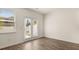 This empty living room features hardwood floors, a ceiling fan, and access to the outside through a glass door at 345 Sound Cir # 134, Stockbridge, GA 30281
