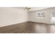 Spacious, naturally lit living room featuring pristine hardwood floors, a ceiling fan, and direct patio access at 345 Sound Cir # 134, Stockbridge, GA 30281