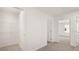 Hallway with coat closet and view into carpeted bedroom at 487 Reflection Dr # 34, Stockbridge, GA 30281