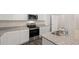 Bright kitchen featuring stainless appliances, granite counters and white cabinetry at 487 Reflection Dr # 34, Stockbridge, GA 30281
