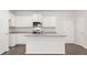 Bright kitchen featuring stainless appliances, granite counters, island and white cabinetry at 487 Reflection Dr # 34, Stockbridge, GA 30281