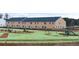 View of the backyard of a townhome featuring a green lawn and playground equipment at 487 Reflection Dr # 34, Stockbridge, GA 30281