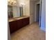 Bathroom featuring dual sinks, granite countertops, and ceramic tile flooring at 2300 Peachford Rd # 1209, Atlanta, GA 30338