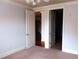 Bedroom with carpet, neutral walls, and access to another room at 2300 Peachford Rd # 1209, Atlanta, GA 30338