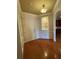 A spacious entryway with hardwood floors, door, built in shelving, and custom trim and molding at 2300 Peachford Rd # 1209, Atlanta, GA 30338