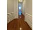 Hallway with pristine wooden floors, custom trim and molding, and archway to other rooms at 2300 Peachford Rd # 1209, Atlanta, GA 30338