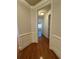 Hallway with hardwood floors, wainscoting and view to another room at 2300 Peachford Rd # 1209, Atlanta, GA 30338