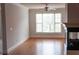 Bright living room with hardwood floors, fireplace, and large window at 2300 Peachford Rd # 1209, Atlanta, GA 30338