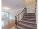 Modern staircase with gray carpeting and black railing at 6980 Roswell Rd # J6, Atlanta, GA 30328