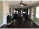 Open-concept living room featuring hardwood floors, a ceiling fan, and a fireplace with a decorative mantle at 148 Murray Hill Ne Ave, Atlanta, GA 30317