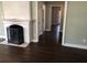 Living room with hardwood floors and a fireplace, leading to a hallway at 148 Murray Hill Ne Ave, Atlanta, GA 30317