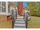 Steps leading up to a deck with a brick fireplace at 1035 Dorris Rd, Douglasville, GA 30134