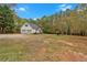 Home's exterior showcases a two-car garage and large yard at 1035 Dorris Rd, Douglasville, GA 30134