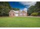 Charming brick home with a spacious front yard and a pristine metal roof at 3598 Brock Rd, Duluth, GA 30096