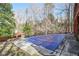 Covered swimming pool in backyard with mature trees and a gazebo in the distance at 1801 Laurel Creek Se Trl, Smyrna, GA 30080