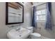 Comfortable bathroom featuring a sink, mirror and blue curtains at 589 Northern Ave, Clarkston, GA 30021
