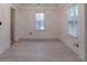 Bright bedroom featuring hardwood floor, crown molding and natural light through the windows at 589 Northern Ave, Clarkston, GA 30021