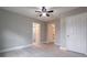 Neutral bedroom with wood flooring, ceiling fan, and ensuite bathroom access at 589 Northern Ave, Clarkston, GA 30021