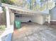 Covered carport with concrete floor, leads to the home's entry at 589 Northern Ave, Clarkston, GA 30021