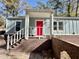 Charming home entrance with red door, white trim, and brick foundation at 589 Northern Ave, Clarkston, GA 30021