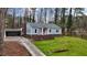 Lovely light blue home with red door, carport, and well-manicured lawn at 589 Northern Ave, Clarkston, GA 30021