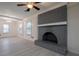 Bright living room with a painted brick fireplace, ceiling fan, and view to the outdoor patio at 589 Northern Ave, Clarkston, GA 30021