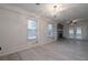 Open-concept living room featuring a painted brick fireplace, hardwood floors and bright natural light at 589 Northern Ave, Clarkston, GA 30021