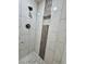 Beautifully tiled shower with built-in shelving and modern fixtures at 589 Northern Ave, Clarkston, GA 30021