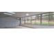 Sunroom with large windows and tile flooring offers beautiful view of surrounding trees at 589 Northern Ave, Clarkston, GA 30021
