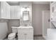 Bathroom featuring updated vanity, mirror, toilet, and a standing shower with tile surround at 1039 Ridgecrest Dr, Smyrna, GA 30080