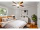 This staged bedroom offers a ceiling fan, light neutral paint, wood floors and a large window at 1039 Ridgecrest Dr, Smyrna, GA 30080