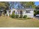 Charming one-story home with a well-manicured lawn and mature trees at 1039 Ridgecrest Dr, Smyrna, GA 30080