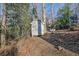 Small storage shed nestled in the woods at 7740 Sagebrush Dr, Atlanta, GA 30350