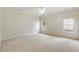 Spacious bedroom with neutral carpeting and two windows at 6202 Talmadge Nw Way, Acworth, GA 30101